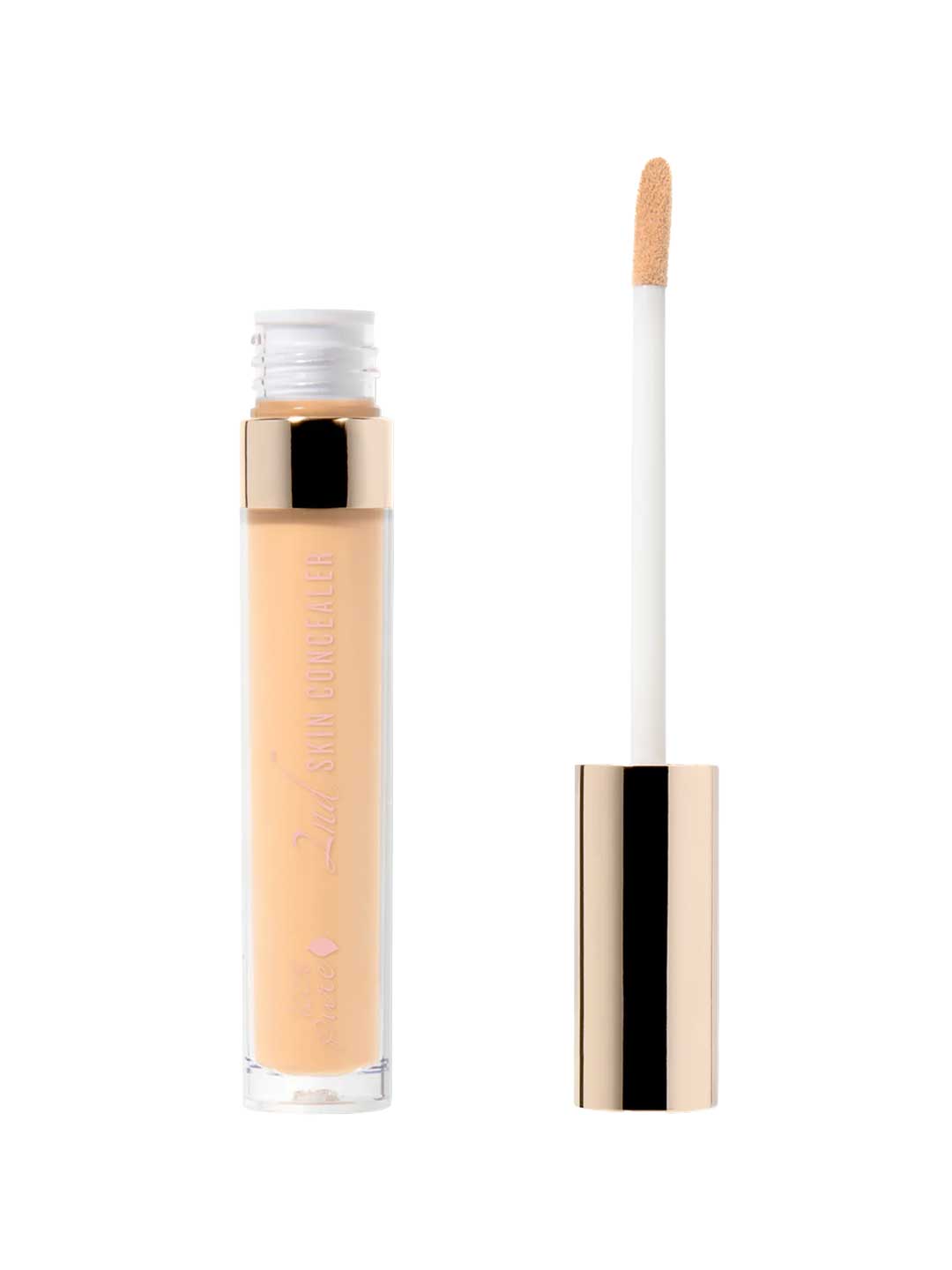 A 5ml tube of 100% Pure 2nd Skin Concealer with a gold cap stands upright next to its wand applicator, featuring a soft, angled tip coated in light beige for buildable coverage and a natural finish.