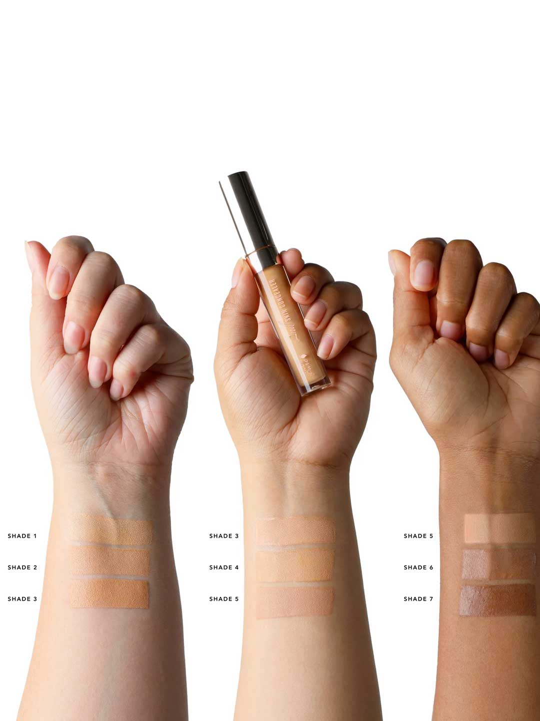 Three arms of varied skin tones display swatches of all seven 100% Pure 2nd Skin Concealer 5ml shades, labeled Shade 1 to Shade 7. The middle hand holds the vegan concealer, showing its natural finish for every complexion.
