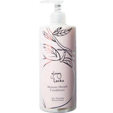 A bottle of 100% Pure Glossy Locks Moisture Drench Conditioner with a pump, made for dry hair, featuring a minimalist leaf pattern and peach outline on a light pink label.