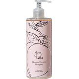 A bottle of 100% Pure Glossy Locks Moisture Drench Shampoo for dry hair, with a pink label featuring a line drawing of a peach and leaves, and a pump dispenser.