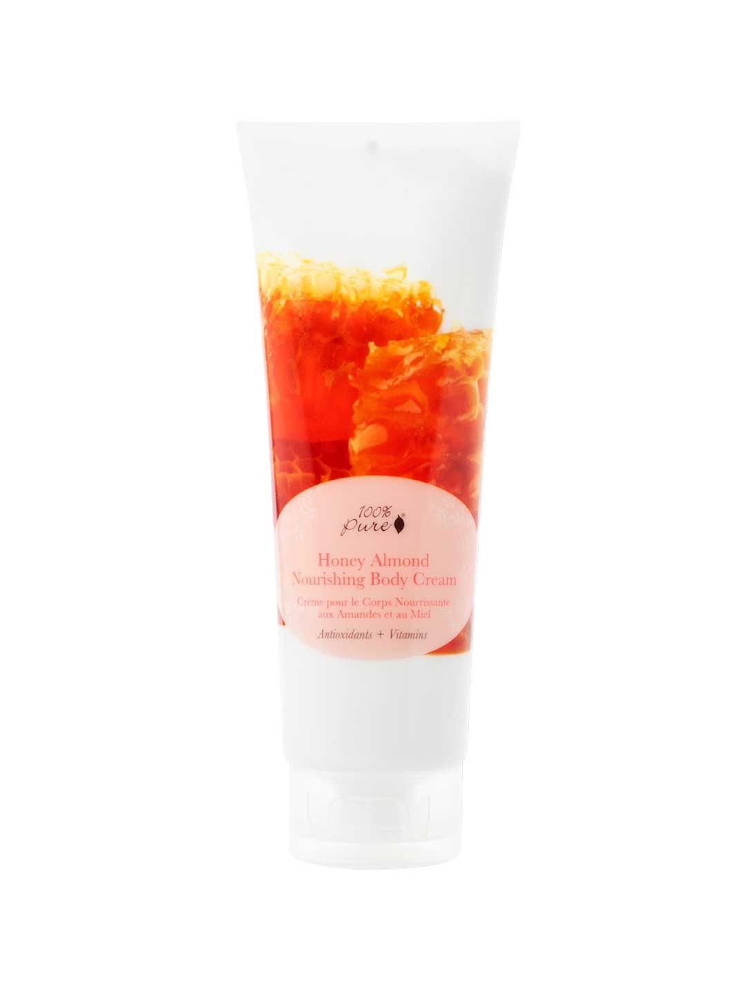 A 236ml tube of 100% Pure Honey Almond Nourishing Body Cream, featuring an orange and yellow design with a pink front label.