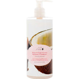 A pump bottle of 100% Pure Honey & Virgin Coconut Restorative Conditioner by 100% Pure, sulfate-free, with pink-accented labeling and cracked coconut imagery on the packaging.
