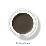 A top view of the 100% Pure Long Last Brows 4.5g by 100% Pure, a small round container filled with medium brown natural brow gel, labeled "Medium Brown" on a white background.