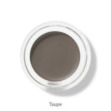 A small round pot of 100% Pure Long Last Brows 4.5g by 100% Pure, filled with taupe long-lasting cream, is viewed from above. The word "Taupe" appears below the container on a white background.