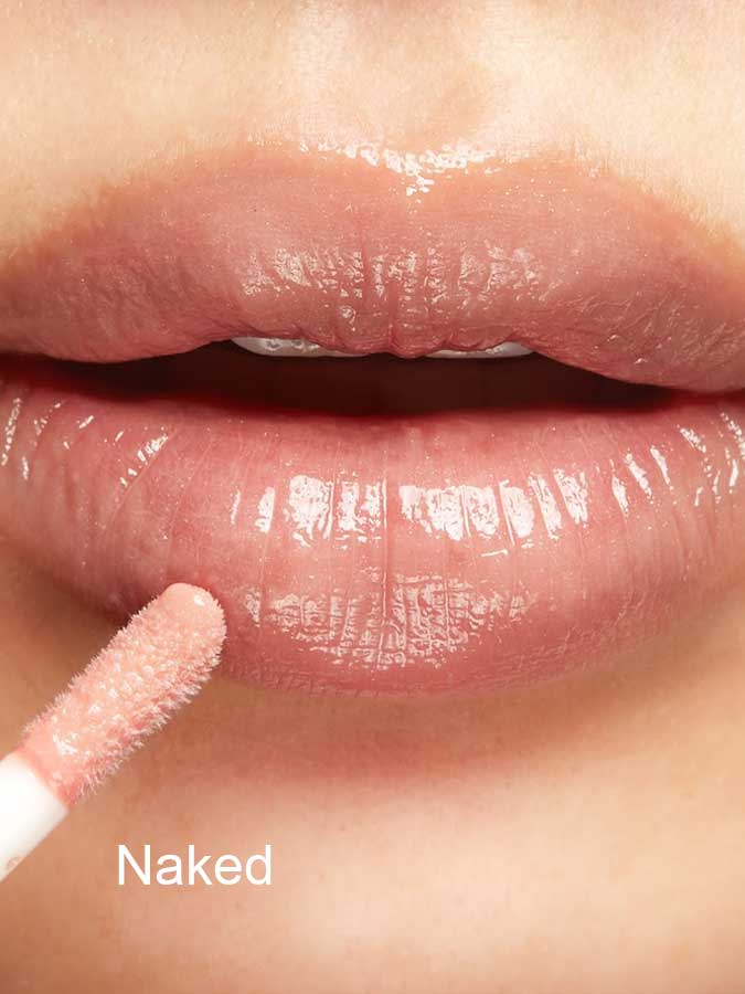 Close-up of lips with ultra shiny 100% Pure Lip Gloss enriched with vitamin E applied using a doe-foot applicator. "Naked" appears in white text at the bottom left.