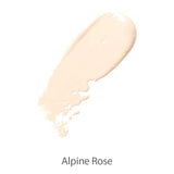 A swatch of 100% Pure Cream Foundation 9g in Alpine Rose, a creamy light beige shade, sits on a white background and highlights its smooth satin finish.