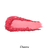 A swatch of bright pink 100% Pure Rice Powder Pressed Blush 9g, textured and smeared on a white background for a natural flush, is labeled Cherry below the image.