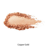 A swatch of 100% Pure Gemmed Luminiser 9g in a warm copper gold shade is spread on a white background, perfect for a natural glow. The text "Copper Gold" appears below the makeup sample.