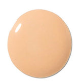 A round, smooth swatch of 100% Pure 2nd Skin Foundation 35ml in light beige provides natural-looking coverage, displayed on a white background.