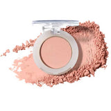 An open 100% Pure Pressed Eye Shadow 2g, a light pink mineral shimmer powder by 100% Pure with a clear lid, sits against a backdrop of matching loose, crushed powder.