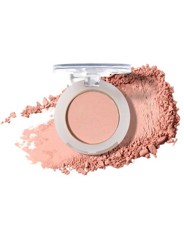 An open 100% Pure Pressed Eye Shadow 2g, a light pink mineral shimmer powder by 100% Pure with a clear lid, sits against a backdrop of matching loose, crushed powder.