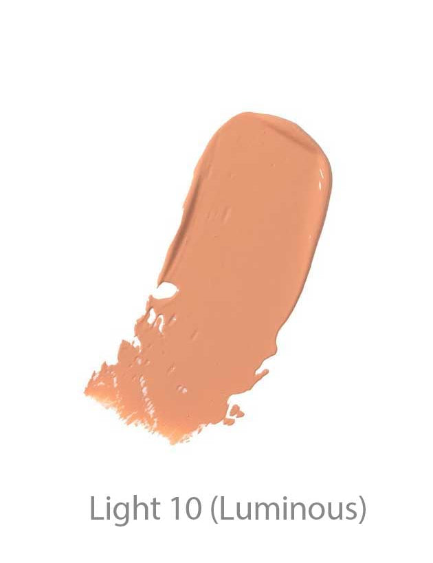 A creamy, light beige swatch of 100% Pure BB Cream 30ml in shade Light 10 (Luminous) blends seamlessly on a white background, showcasing its makeup-skincare hybrid formula.