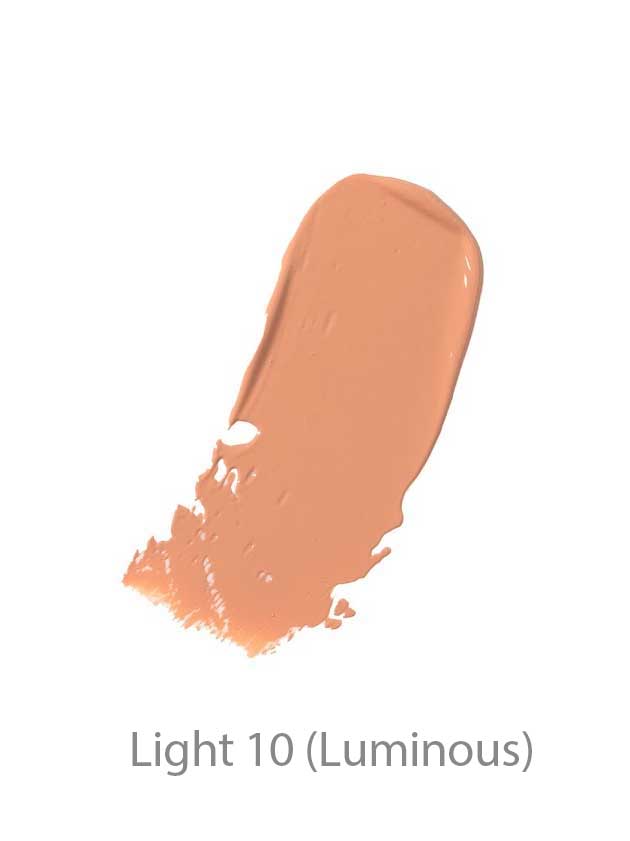 A creamy, light beige swatch of 100% Pure BB Cream 30ml in shade Light 10 (Luminous) blends seamlessly on a white background, showcasing its makeup-skincare hybrid formula.