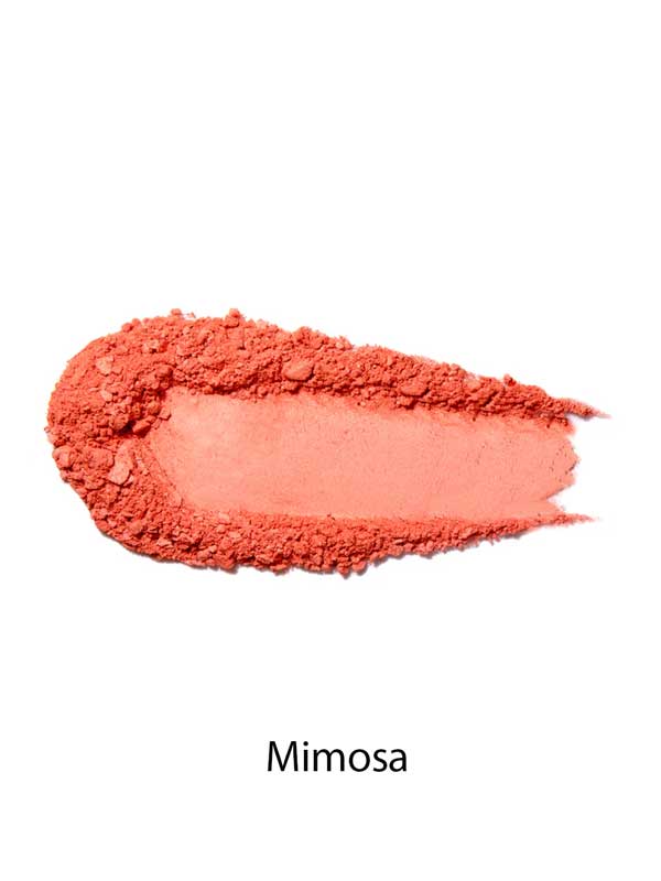 A swatch of 100% Pure Rice Powder Pressed Blush 9g in peachy coral Mimosa is displayed on a white background, showcasing its natural flush and buildable coverage.