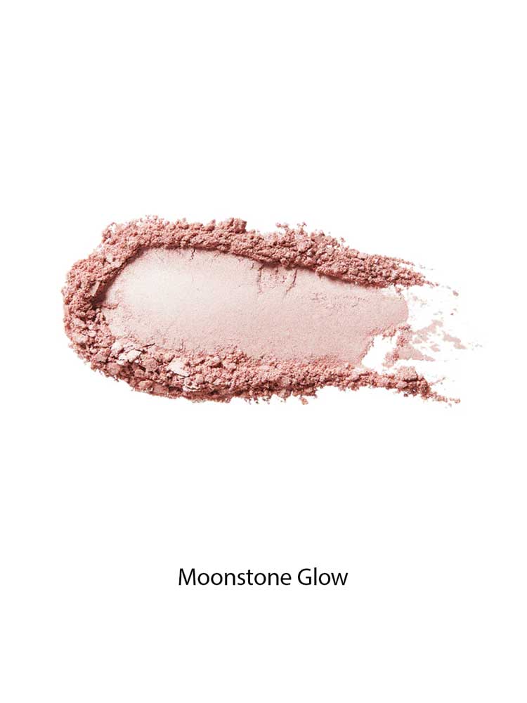 A swatch of 100% Pure Gemmed Luminiser 9g, a shimmery pink pressed powder, is smeared on a white background—perfect for adding a natural glow.