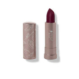 A 4.5g tube of 100% Pure Cocoa Butter Matte Lipstick in the shade Oasis (a berry wine), cap off to reveal the deep berry color. The light mauve tube is adorned with white botanical designs for an elegant touch.