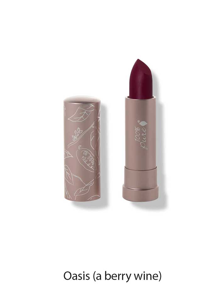 A 4.5g tube of 100% Pure Cocoa Butter Matte Lipstick in the shade Oasis (a berry wine), cap off to reveal the deep berry color. The light mauve tube is adorned with white botanical designs for an elegant touch.