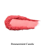 A swipe of 100% Pure Rice Powder Pressed Blush 9g in bright pink on a white background with the label Peppermint Candy, delivering a natural flush and buildable coverage.