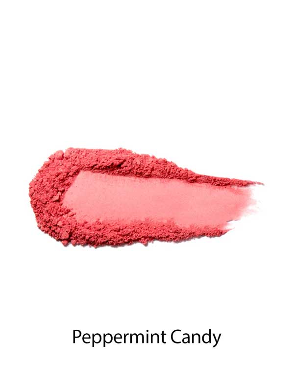 A swipe of 100% Pure Rice Powder Pressed Blush 9g in bright pink on a white background with the label Peppermint Candy, delivering a natural flush and buildable coverage.