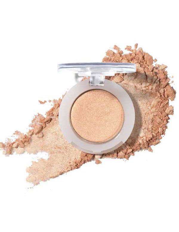 An open compact of 100% Pure Pressed Eye Shadow 2g by 100% Pure in shimmery beige, with a light dusting of powder around it on a white background.