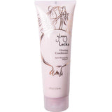 A pink 8 fl oz (236 ml) tube of 100% Pure Glossy Locks Glossing Conditioner with a floral design and black text. Enriched with biotin and coconut oil for glossy, hydrated hair. Bottom cap for easy dispensing.